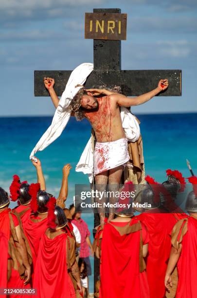 Man playing the role of Jesus Christ lies on the cross during the representation of 'The Way of The Cross' as part of the Holy Week celebrations at...