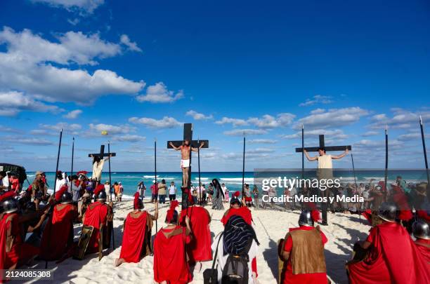 Man playing the role of Jesus Christ lies on the cross during the representation of 'The Way of The Cross' as part of the Holy Week celebrations at...