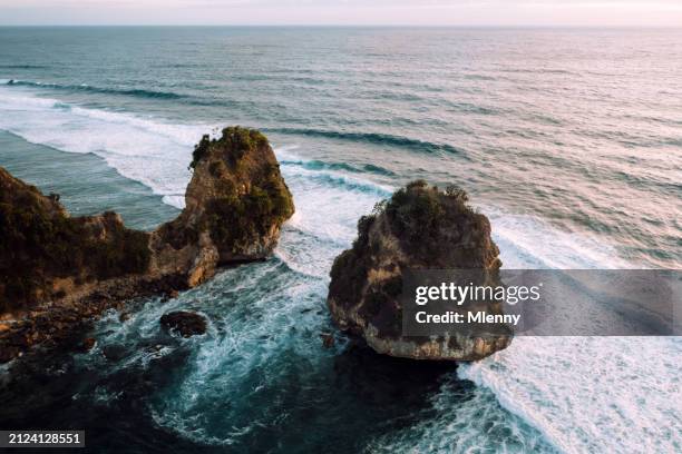 sumba island nihisumba beach twin rocks in sunset sumba indonesia - pinnacle rock stock pictures, royalty-free photos & images