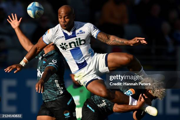 Mark Tele’a of the Blues is brought down by Fine Inisi of Moana during the round six Super Rugby Pacific match between Moana Pasifika and Blues at...
