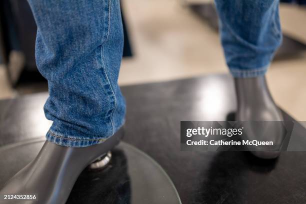 hem of denim blue jeans on mannequin in retail store - hem stock pictures, royalty-free photos & images