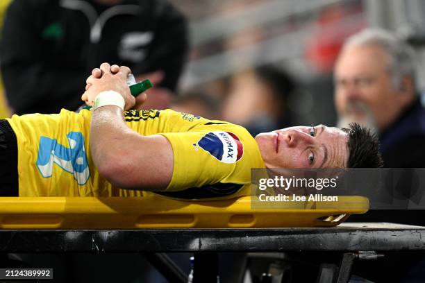 Cam Roigard of the Hurricanes leaves the field of play after sustaining an injury during the round six Super Rugby Pacific match between Highlanders...