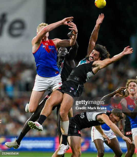 Jacob van Rooyen of the Demons competes for a mark over Kane Farrell against Lachie Jones and Aliir Aliir of the Power during the round three AFL...