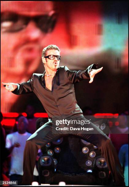 Pop star George Michael performs live on stage at netAID held at Wembley Stadium, London on October 9 1999. There were three concerts held across the...