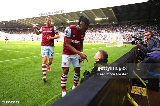 Mohammed Kudus of West Ham United interacts with a ball person as he celebrates scoring his team's second goal during the Premier League match...