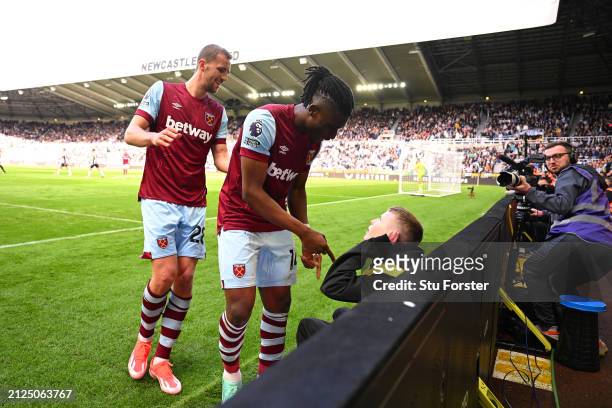 Mohammed Kudus of West Ham United interacts with a ball person as he celebrates scoring his team's second goal during the Premier League match...