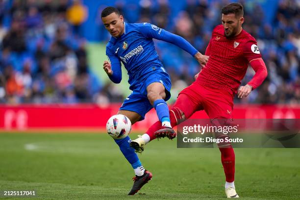Mason Greenwood of Getafe CF battles for the ball with Nemanja Gudelj of Sevilla FC during the LaLiga EA Sports match between Getafe CF and Sevilla...