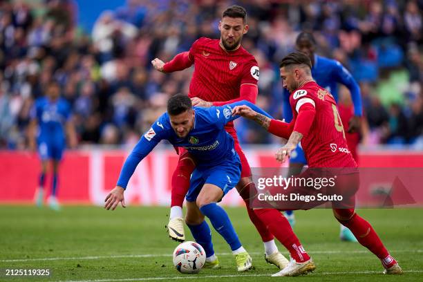 Oscar Rodriguez of Getafe CF battles for the ball with Nemanja Gudelj of Sevilla FC during the LaLiga EA Sports match between Getafe CF and Sevilla...