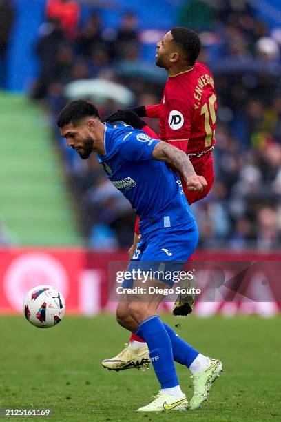 Omar Alderete of Getafe CF battles for the ball with Youssef En Nesyri of Sevilla FC during the LaLiga EA Sports match between Getafe CF and Sevilla...