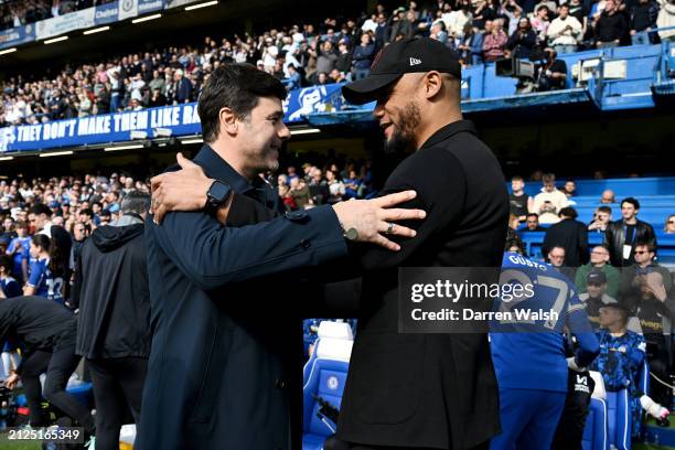 Mauricio Pochettino, Manager of Chelsea, and Vincent Kompany, Manager of Burnley, interact prior to the Premier League match between Chelsea FC and...