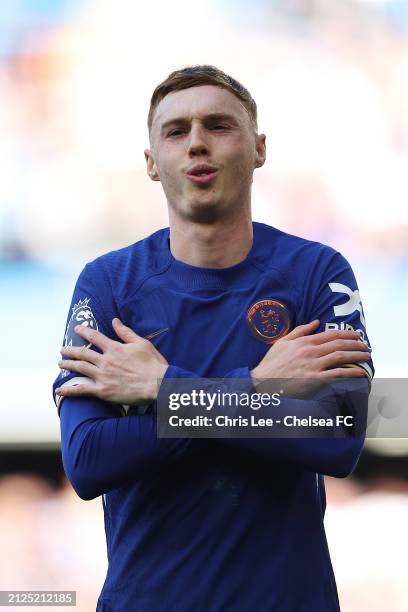 Cole Palmer of Chelsea celebrates scoring his team's first goal from a penalty kick during the Premier League match between Chelsea FC and Burnley FC...