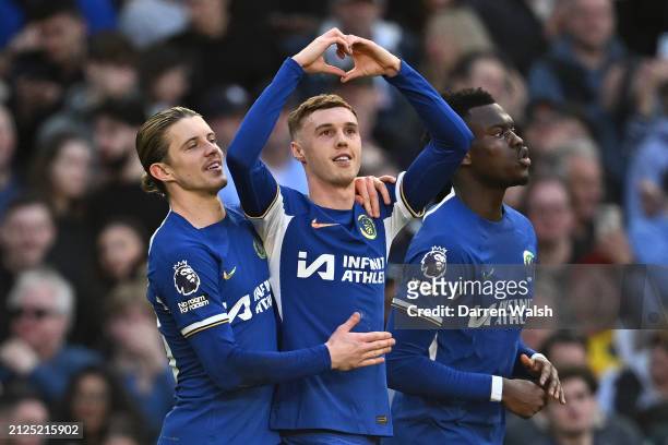Cole Palmer of Chelsea celebrates scoring his team's first goal from a penalty kick with teammates Conor Gallagher and Benoit Badiashile during the...