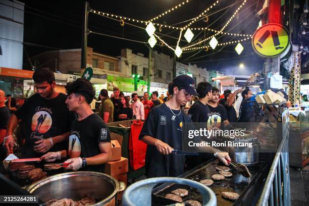 Food vendors cook camel burgers at Ramadan Nights Lakemba on March 30, 2024 in Sydney, Australia. The Ramadan Nights festival in the Sydney suburb of...