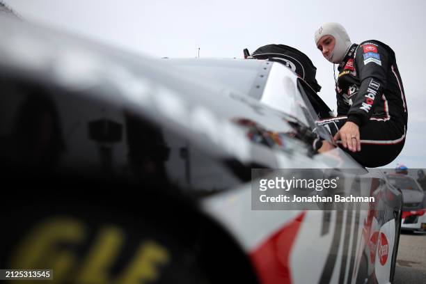 Christopher Bell, driver of the Mobil 1 Toyota, enters his car during qualifying for the NASCAR Cup Series Toyota Owners 400 at Richmond Raceway on...