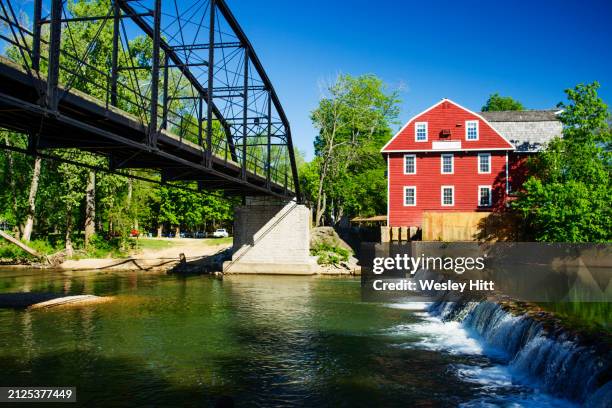 war eagle mill outside of rogers, arkansas with a waterfall and old bridge over war eagle river. - fayetteville arkansas stock pictures, royalty-free photos & images