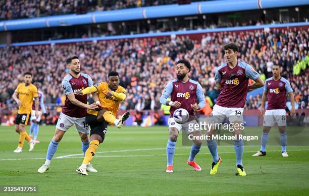 Nelson Semedo of Wolverhampton Wanderers shoots whilst under pressure from Alex Moreno, Douglas Luiz and Pau Torres of Aston Villa during the Premier...