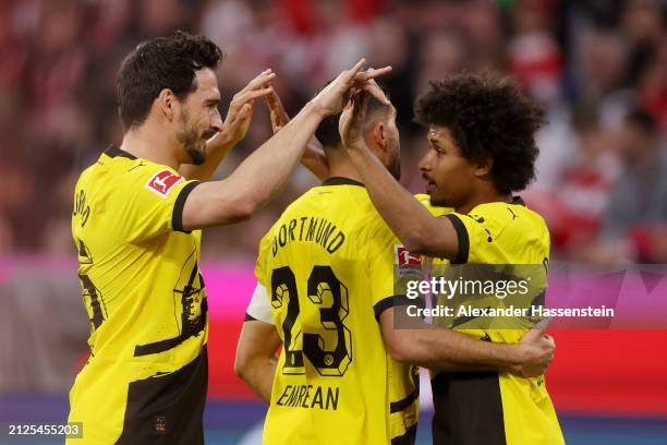 Karim Adeyemi of Borussia Dortmund celebrates scoring his team's first goal with teammates Mats Hummels and Emre Can during the Bundesliga match...