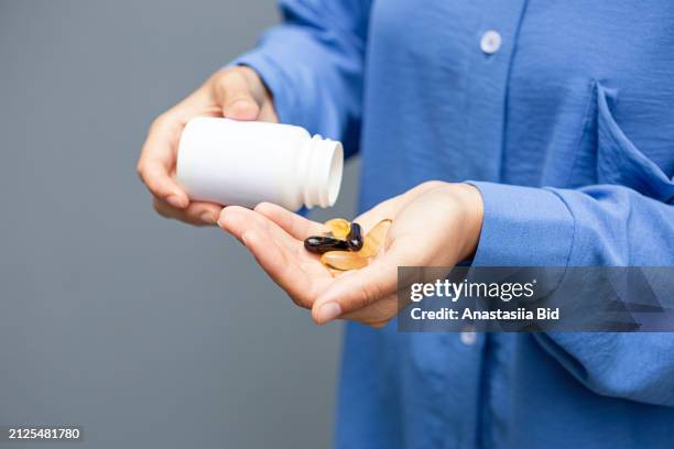 closeup photography of woman hands,shaking on the hand pills from blank jar.banner with copy space. - ace bandage stock pictures, royalty-free photos & images