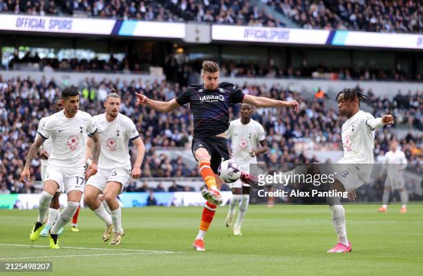 Reece Burke of Luton Town controls the ball during the Premier League match between Tottenham Hotspur and Luton Town at Tottenham Hotspur Stadium on...