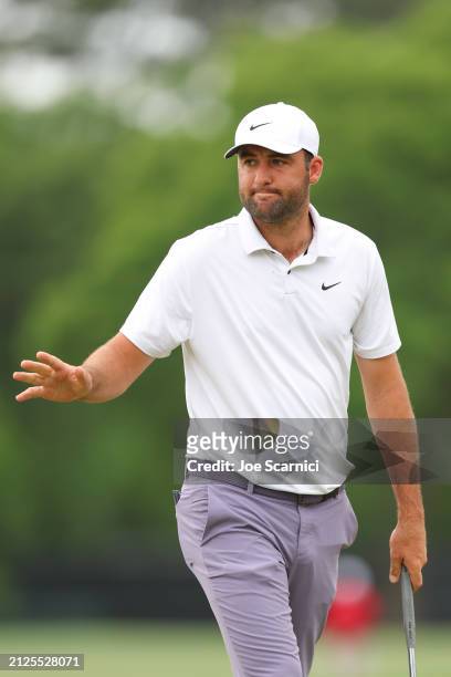 Scottie Scheffler of the United States acknowledges fans after a putt on the sixth green during the third round of the Texas Children's Houston Open...