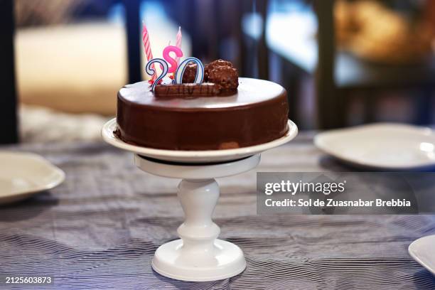 closeup of a chocolate cake with chocolates and candles - birthday candle number stock pictures, royalty-free photos & images