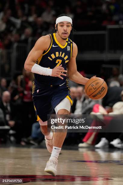 Andrew Nembhard of the Indiana Pacers dribbles the ball during the second half against the Chicago Bulls at the United Center on March 27, 2024 in...