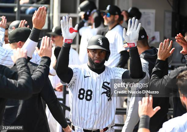 Luis Robert Jr. #88 of the Chicago White Sox is congratulated by teammates following a two run home run during the third inning of a game against the...