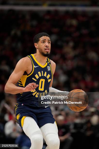 Tyrese Haliburton of the Indiana Pacers dribbles the ball during the second half against the Chicago Bulls at the United Center on March 27, 2024 in...