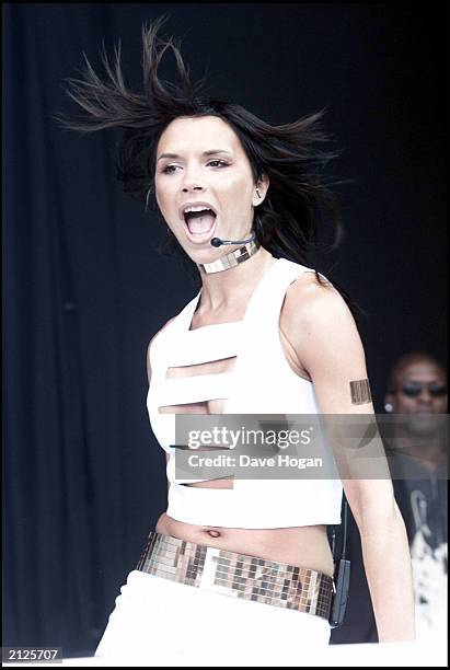 Former Spice Girl Victoria Beckham performs on stage with the Truesteppers at Party in the Park, Hyde Park, London on July 9, 2000. This was...