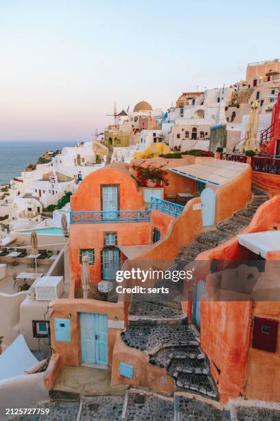 beautiful summer vacation landscape of iconic blue domed churches along the caldera edge at sunny morning against clear blue sky in oia, santorini, caldera, greek islands, greece - mediterranean-blue-roof-santorini stock pictures, royalty-free photos & images