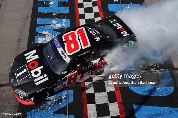 Chandler Smith, driver of the Mobil 1 Toyota, celebrates with a burnout after winning the NASCAR Xfinity Series ToyotaCare 250 at Richmond Raceway on...