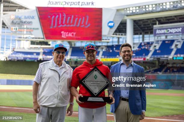 Skip Schumaker of the Miami Marlins receives the Manager of the Year award before the game against the Pittsburgh Pirates at loanDepot park on March...