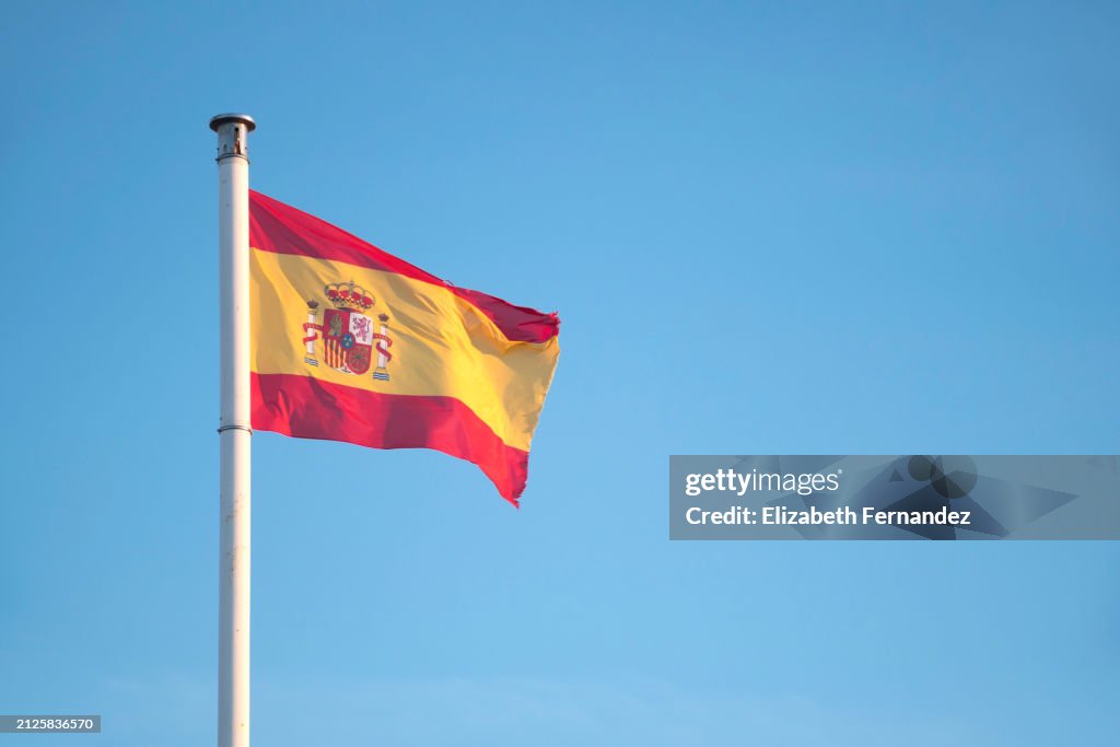 The Flag of Spain Waving Against Sky