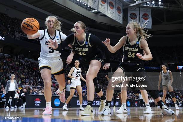 Sydney Affolter of the Iowa Hawkeyes, Charlotte Whittaker of the Colorado Buffaloes and Maddie Nolan of the Colorado Buffaloes battle for the ball...