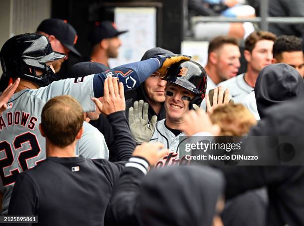Mark Canha of the Detroit Tigers is congratulated by Parker Meadows of the Detroit Tigers after scoring the winning run during the tenth inning of a...