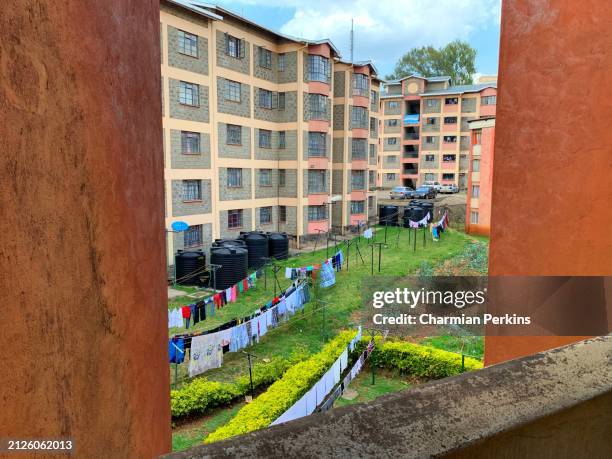 tenement buildings in nairobi, kenya. east african urban homes with gardens and colourful washing on line outside - nairobi county stock pictures, royalty-free photos & images