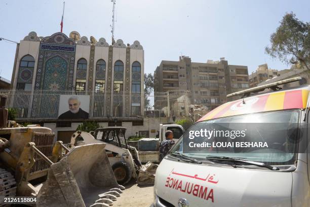 Rescue workers search in the rubble of a building annexed to the Iranian embassy a day after an air strike in Damascus on April 2, 2024. Iran warned...