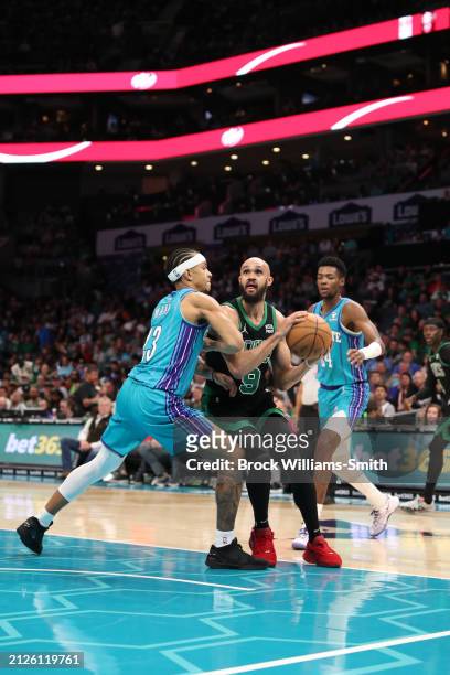 Derrick White of the Boston Celtics handles the ball during the game against the Charlotte Hornets on April 1, 2024 at Spectrum Center in Charlotte,...