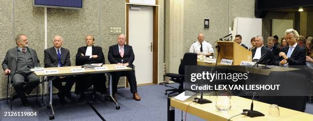 Expert witnesses Arabist Hans Jansen and Middle East expert Bertus Hendriks sit with lawyer Van Eijck and Tom Schalken, co-author of the prosecutions...