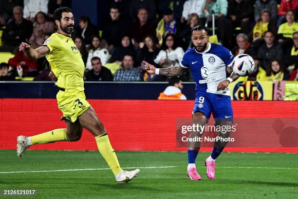 Villarreal's Raul Albiol and Memphis Depay of Atletico de Madrid are competing during the La Liga match between Villarreal CF and Atletico de Madrid...