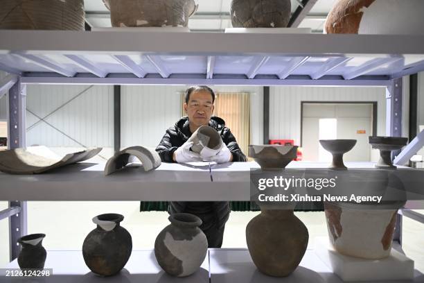 Lei Jianhong, head of the archaeologist group from the Hebei provincial institute of cultural relics and archaeology, arranges cultural relics of the...