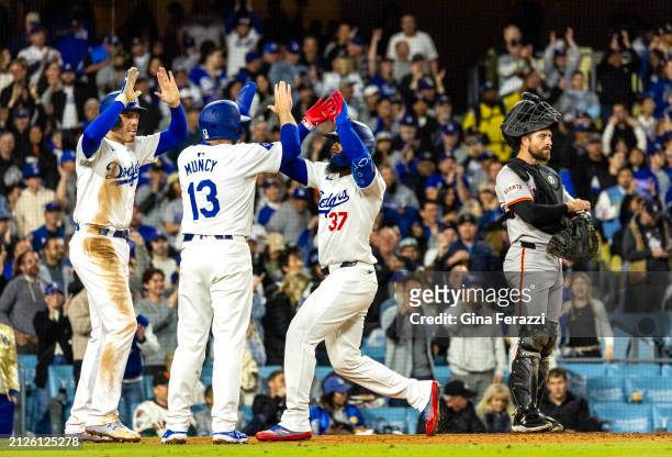 Los Angeles Dodgers left fielder Teoscar Hernandez gets high fives from Los Angeles Dodgers third baseman Max Muncy and Los Angeles Dodgers first...
