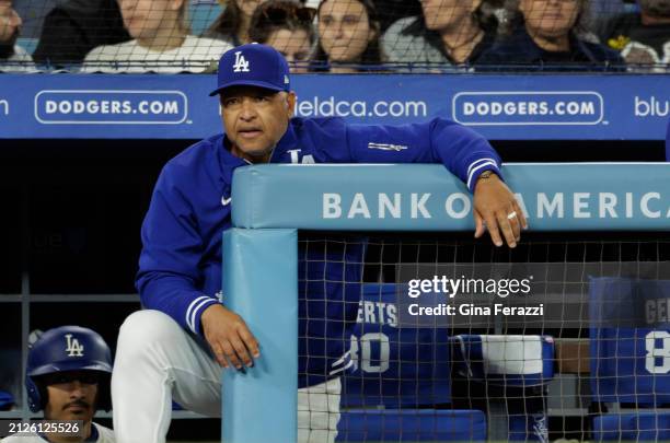 Los Angeles Dodger manager Dave Roberts looks on from the dugout during the Dodgers 8-3 win over the San Francisco Giants at Dodger Stadium on April...