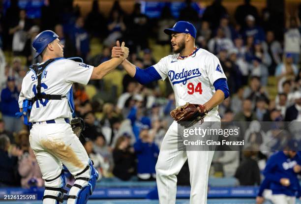 Los Angeles Dodger relief pitcher Dinelson Lamet shakes hands with Dodgers catcher Will Smith after striking out San Francisco Giants third baseman...