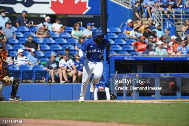 Miguel Hiraldo of the Toronto Blue Jays runs out a fly ball during the eighth inning of a spring training game against the Baltimore Orioles at TD...