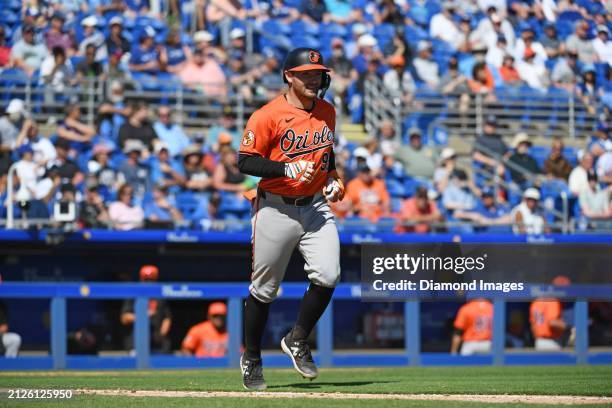 Maverick Handley of the Baltimore Orioles takes first base after being hit by a pitch during the eighth inning of a spring training game against the...