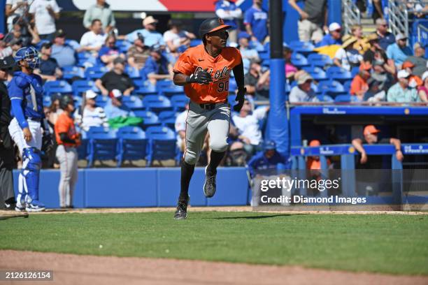Errol Robinson of the Baltimore Orioles runs out a triple during the eighth inning of a spring training game against the Toronto Blue Jays at TD...