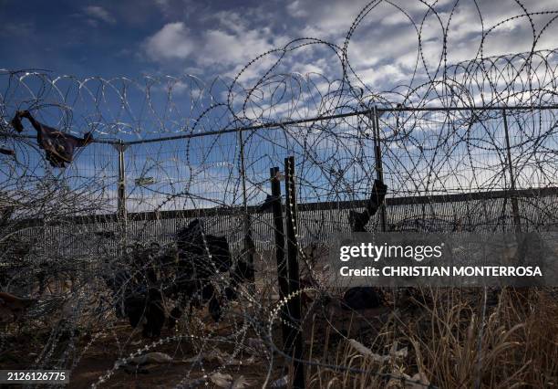 Graphic content / Clothes litter a US-Mexico border fence in Ciudad Juarez, Chihuahua, Mexico, looking into El Paso, Texas, on April 2, 2024. An...