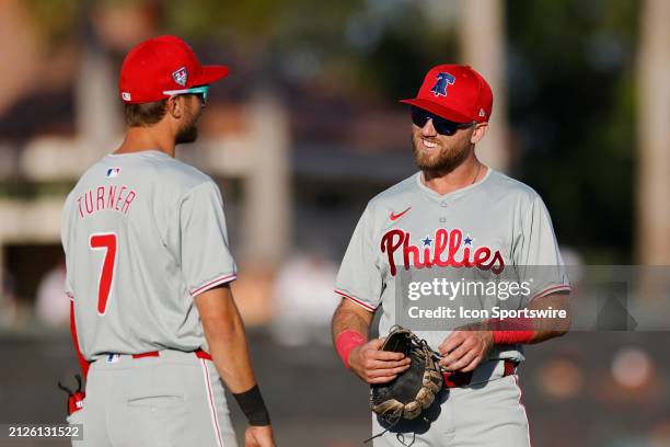 Philadelphia Phillies third baseman Kody Clemens talks with shortstop Trea Turner during an MLB spring training game against the Baltimore Orioles on...