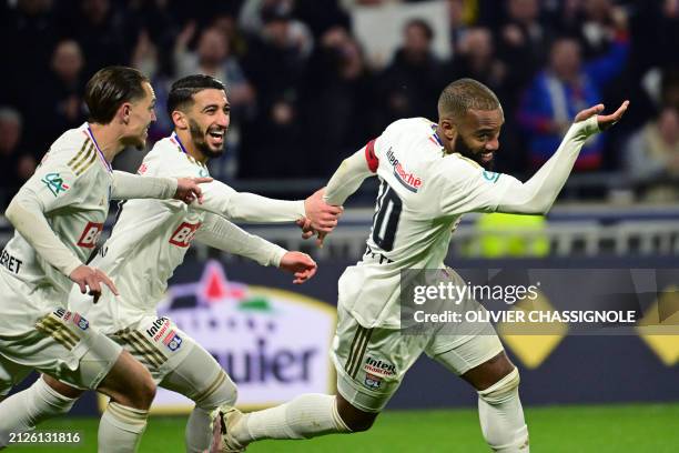 Lyon's French forward Alexandre Lacazette celebrates with teammates after scoring his team's first goal during the French Cup semi final match...
